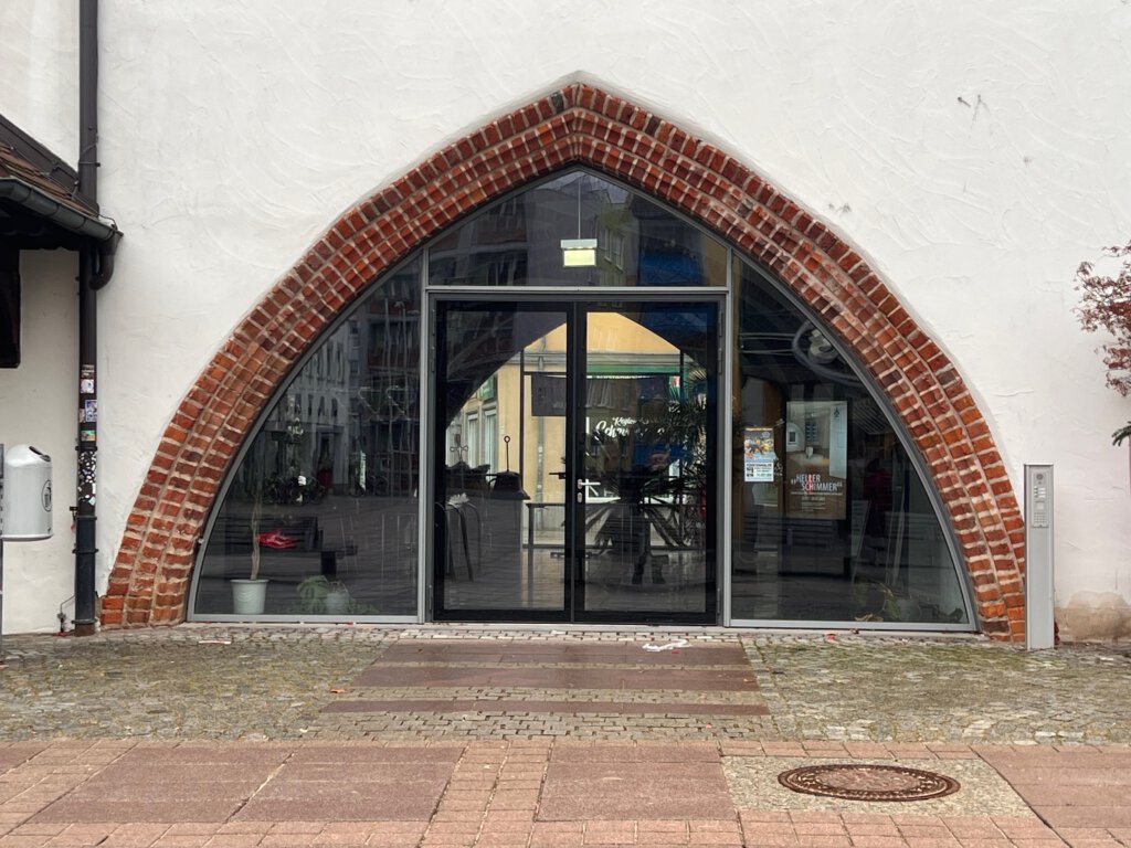 Torbogen mit moderner Glastür als Eingang ins Rathaus von Fürstenwalde